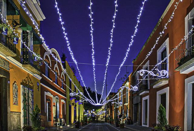 Colourful street, Callejon de los Sapos - Alley of the Toads at night decorated with Christmas lights in Puebla, Mexico 